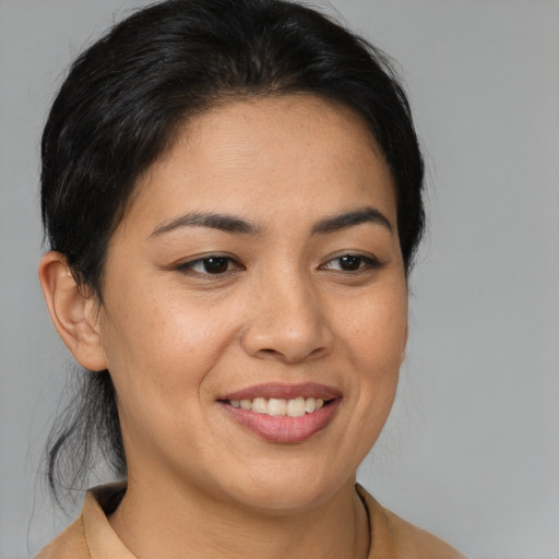 Joyful latino young-adult female with medium  brown hair and brown eyes