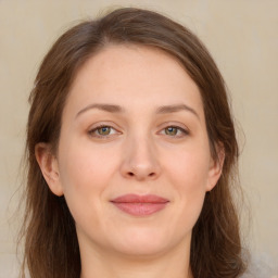 Joyful white young-adult female with long  brown hair and green eyes