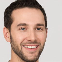 Joyful white young-adult male with short  brown hair and brown eyes