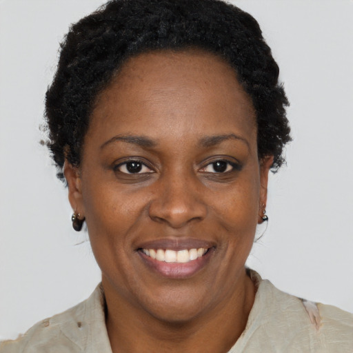 Joyful black adult female with short  black hair and brown eyes
