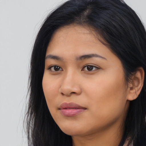 Joyful asian young-adult female with long  black hair and brown eyes