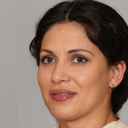 Joyful white adult female with medium  brown hair and brown eyes