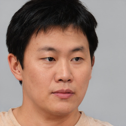 Neutral asian young-adult male with short  brown hair and brown eyes