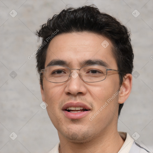 Joyful white adult male with short  black hair and brown eyes