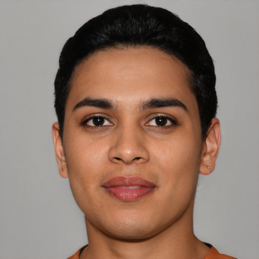 Joyful latino young-adult male with short  black hair and brown eyes