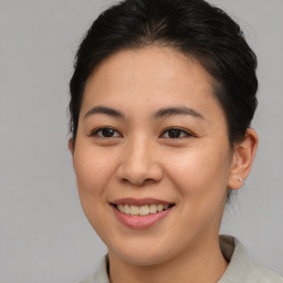 Joyful asian young-adult female with short  brown hair and brown eyes