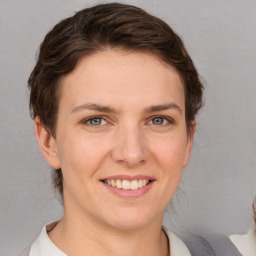 Joyful white young-adult female with short  brown hair and grey eyes