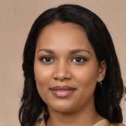 Joyful black young-adult female with long  brown hair and brown eyes