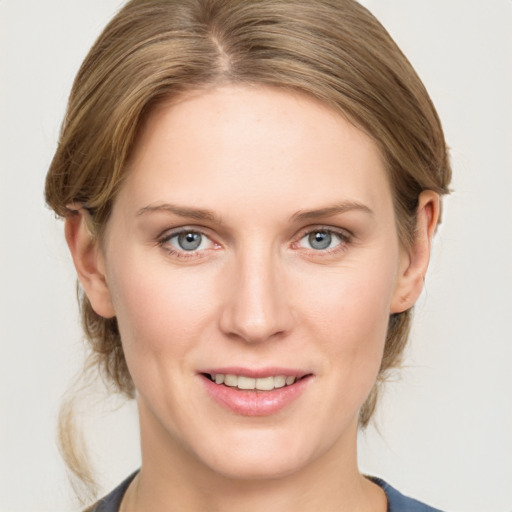 Joyful white young-adult female with medium  brown hair and grey eyes