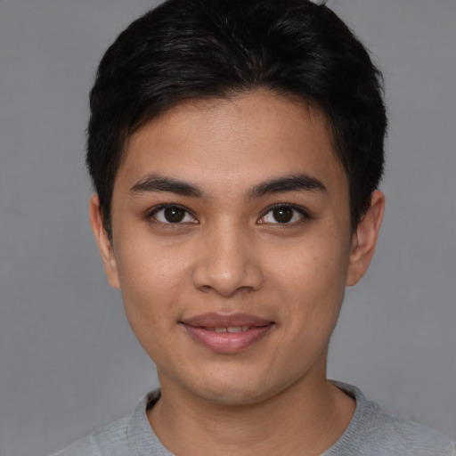 Joyful asian young-adult male with short  brown hair and brown eyes
