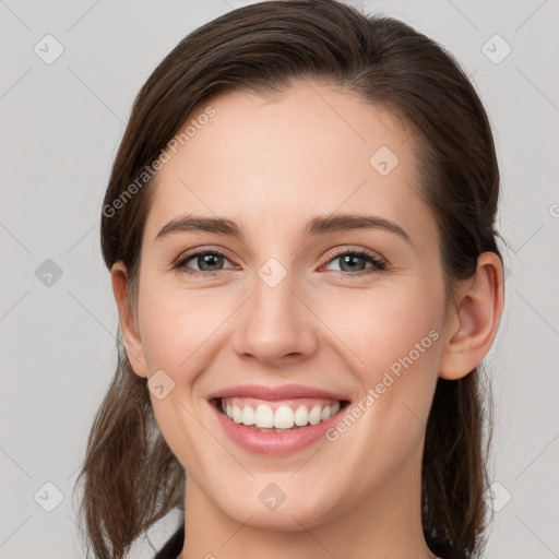 Joyful white young-adult female with medium  brown hair and grey eyes