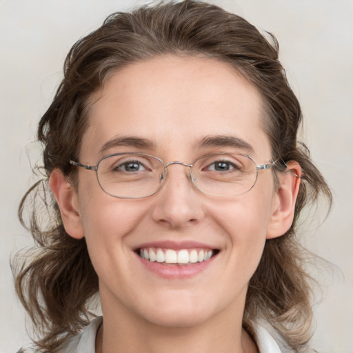 Joyful white adult female with medium  brown hair and blue eyes