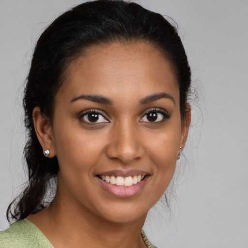 Joyful latino young-adult female with medium  brown hair and brown eyes