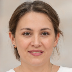 Joyful white young-adult female with medium  brown hair and brown eyes