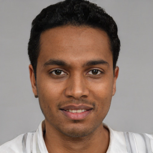 Joyful latino young-adult male with short  black hair and brown eyes
