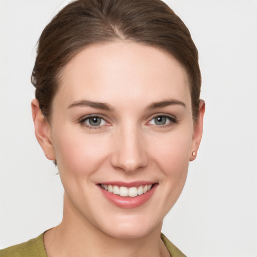 Joyful white young-adult female with short  brown hair and grey eyes