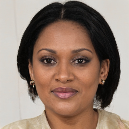 Joyful black adult female with medium  brown hair and brown eyes