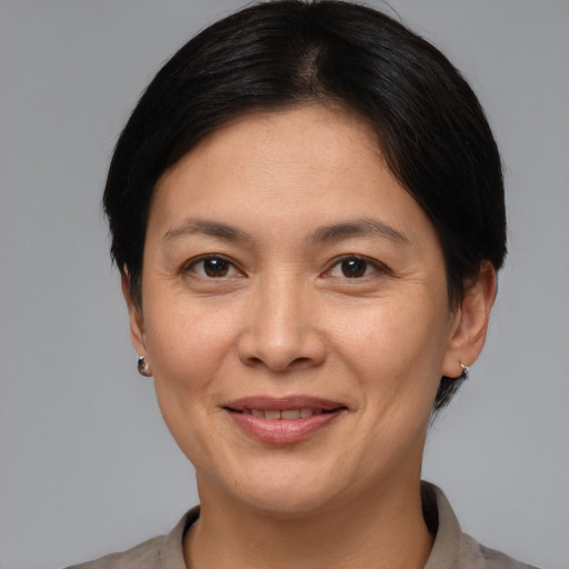 Joyful white adult female with medium  brown hair and brown eyes