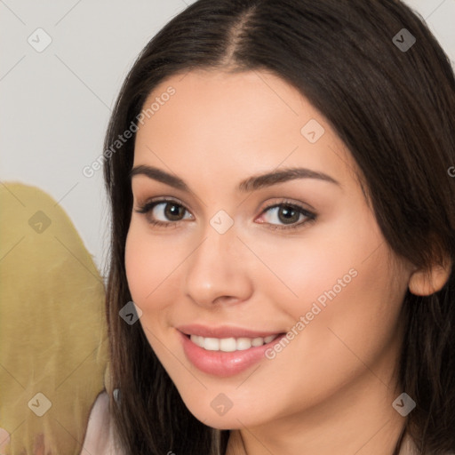 Joyful white young-adult female with long  brown hair and brown eyes