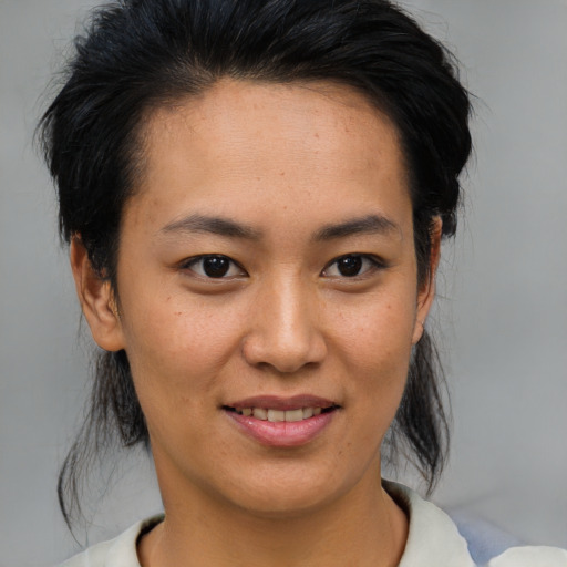 Joyful asian young-adult female with medium  brown hair and brown eyes