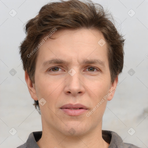 Joyful white adult male with short  brown hair and grey eyes