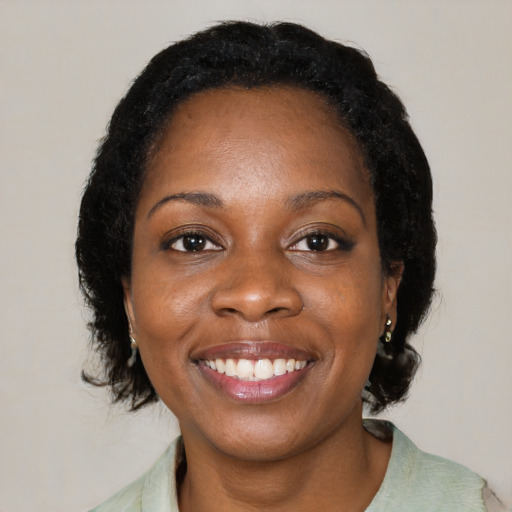 Joyful black young-adult female with medium  black hair and brown eyes