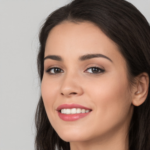 Joyful white young-adult female with long  black hair and brown eyes