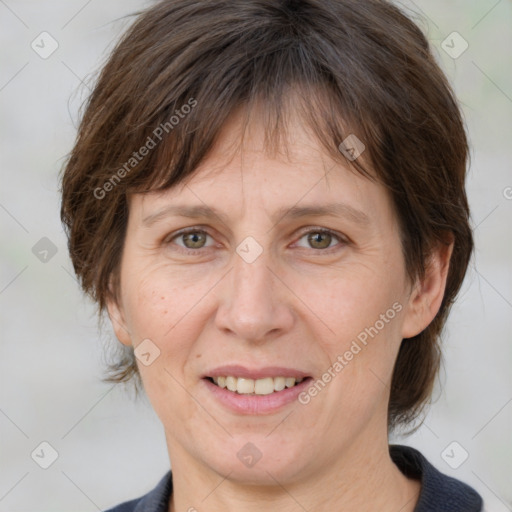 Joyful white adult female with medium  brown hair and grey eyes