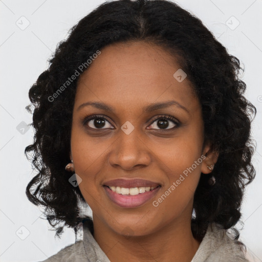 Joyful black young-adult female with long  brown hair and brown eyes