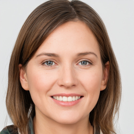 Joyful white young-adult female with long  brown hair and grey eyes