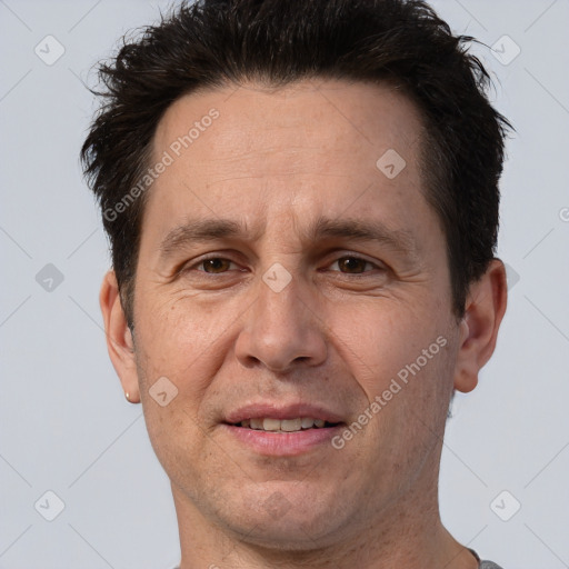 Joyful white adult male with short  brown hair and brown eyes