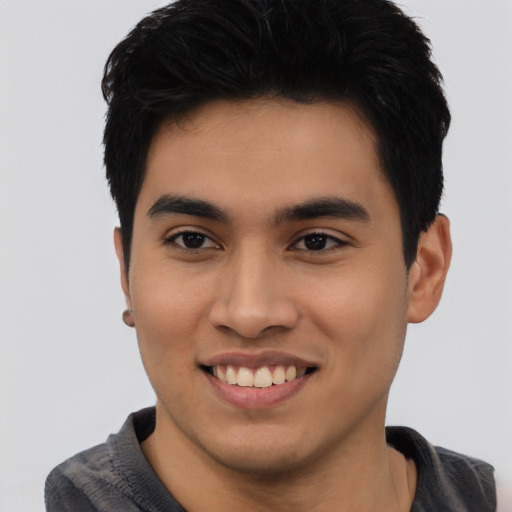 Joyful asian young-adult male with short  black hair and brown eyes