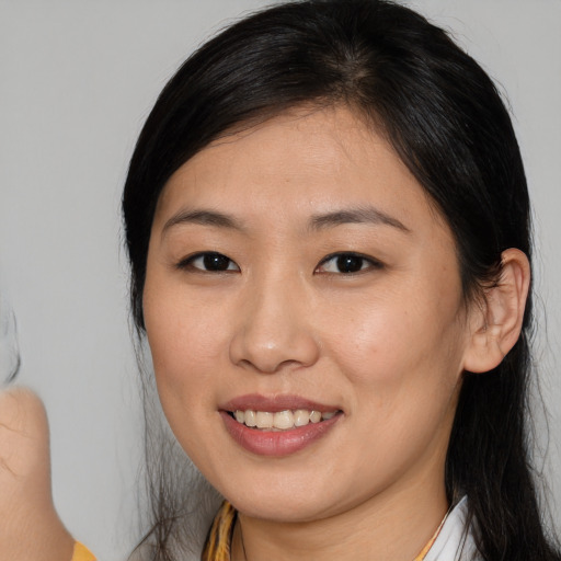 Joyful asian young-adult female with medium  brown hair and brown eyes