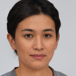 Joyful asian young-adult female with short  brown hair and brown eyes