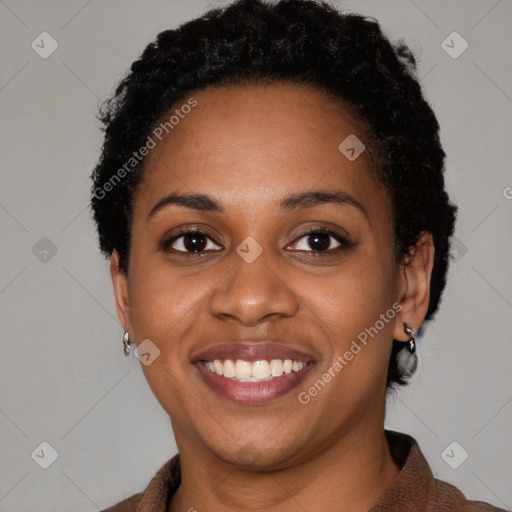 Joyful black young-adult female with short  black hair and brown eyes