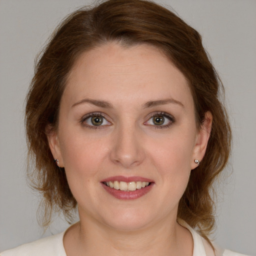 Joyful white young-adult female with medium  brown hair and blue eyes