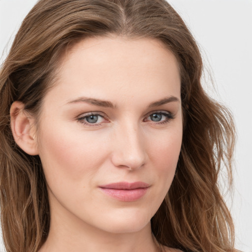 Joyful white young-adult female with long  brown hair and blue eyes