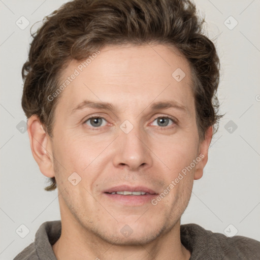 Joyful white adult male with short  brown hair and grey eyes