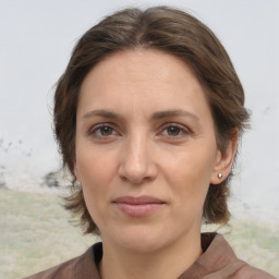 Joyful white adult female with medium  brown hair and brown eyes