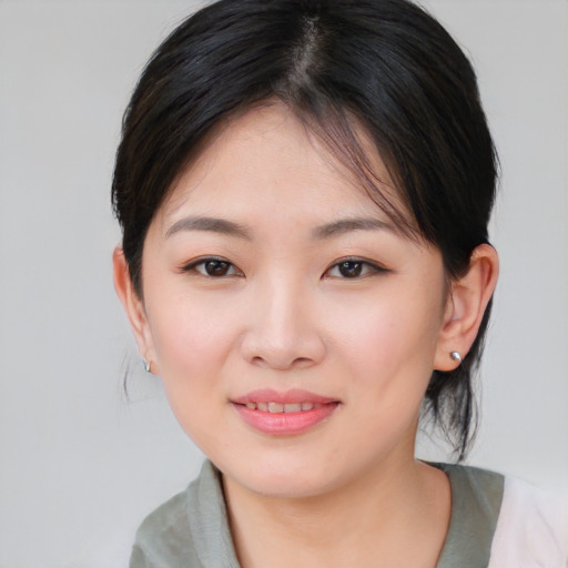 Joyful asian young-adult female with medium  brown hair and brown eyes
