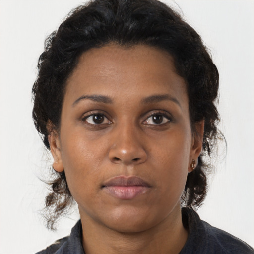 Joyful black young-adult female with medium  brown hair and brown eyes