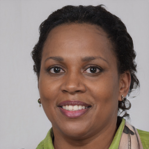 Joyful black adult female with short  brown hair and brown eyes