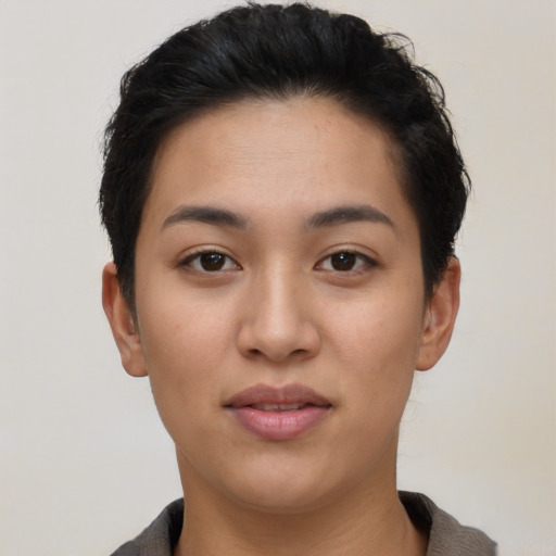 Joyful latino young-adult female with short  black hair and brown eyes