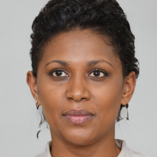 Joyful black young-adult female with short  brown hair and brown eyes
