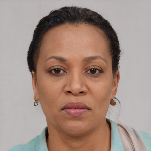 Joyful black adult female with short  brown hair and brown eyes