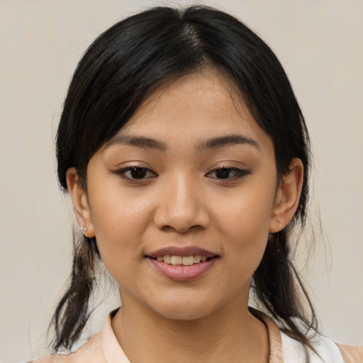 Joyful asian young-adult female with medium  black hair and brown eyes