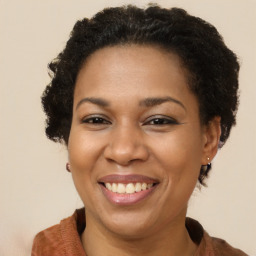 Joyful black adult female with short  brown hair and brown eyes