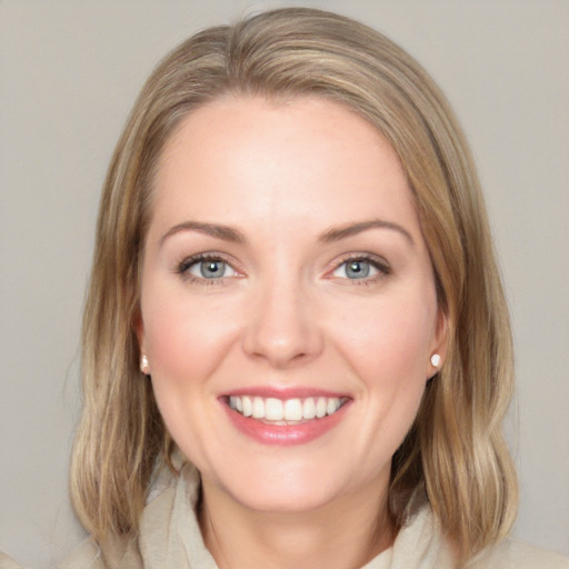 Joyful white young-adult female with medium  brown hair and blue eyes