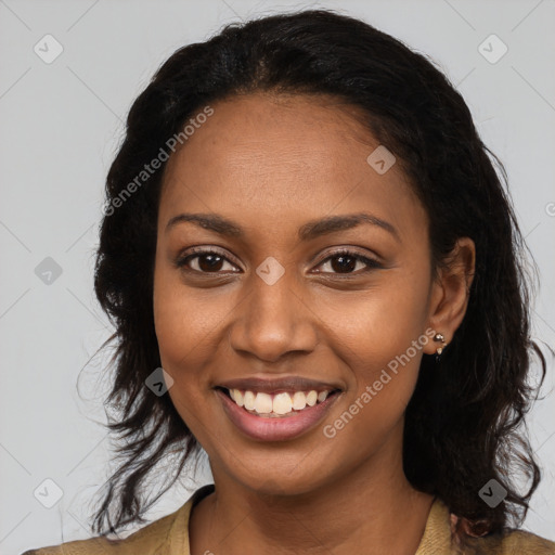 Joyful black young-adult female with long  brown hair and brown eyes