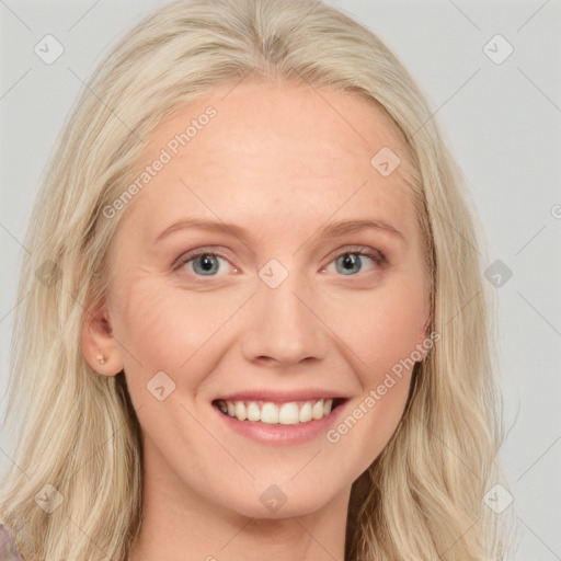 Joyful white young-adult female with long  blond hair and blue eyes